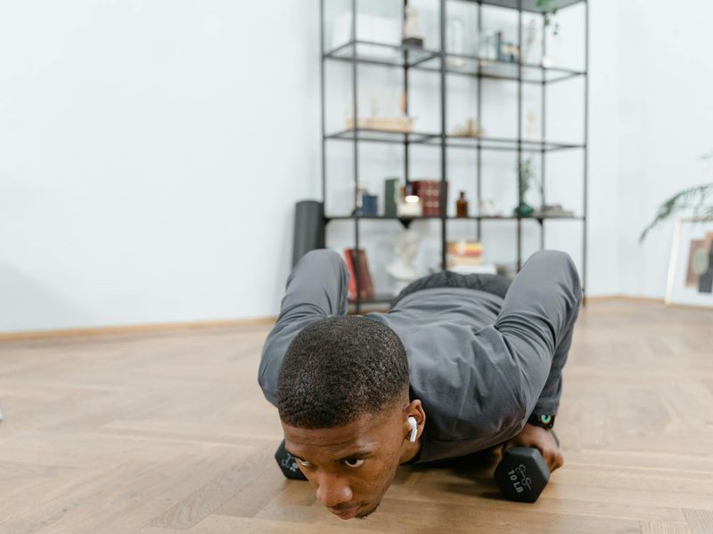 A focused man performing a dumbbell row with perfect form.