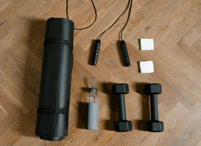 Minimalist home gym space with a mat and dumbbells.